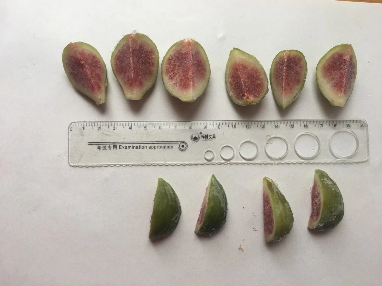 Company-supplied cut figs showing flesh, skin and a ruler