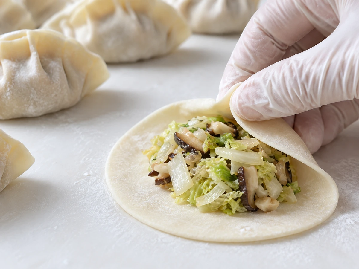 Dumpling wrapper with centered cabbage filling and a clean dough border