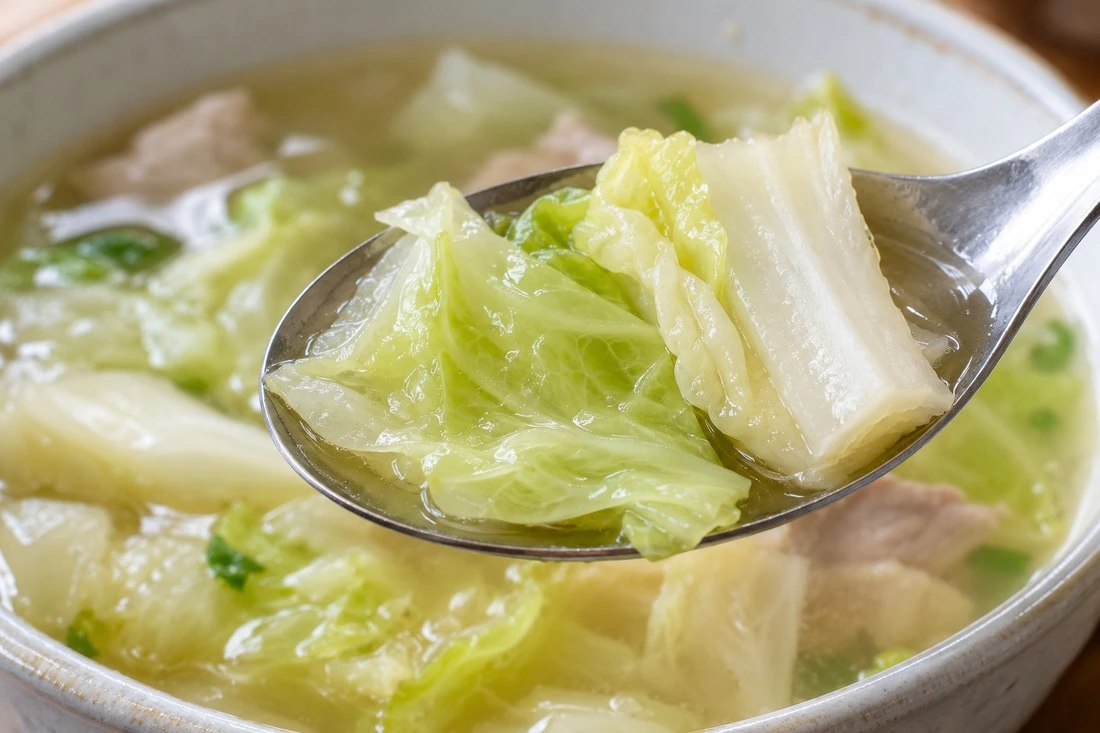 Cooked cabbage leaf and rib on a soup spoon Cooked cabbage leaf and rib on a soup spoon