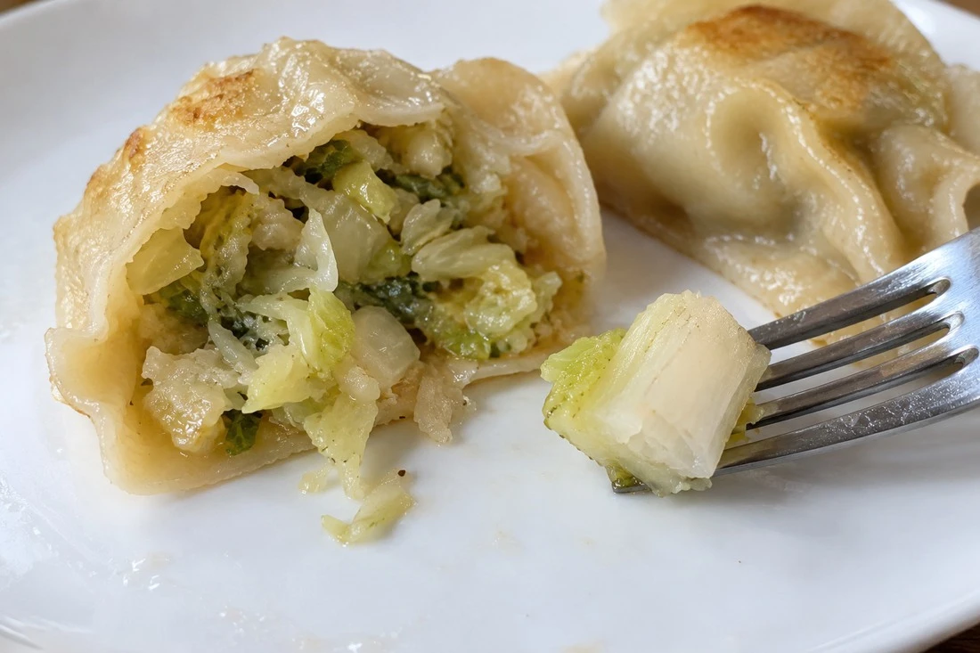 Dense cabbage piece beside a cooked dumpling filling Dense cabbage piece beside a cooked dumpling filling