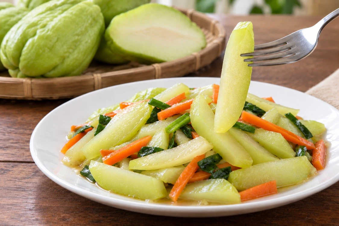 Cooked chayote strips lifted from a vegetable blend Cooked chayote strips lifted from a vegetable blend