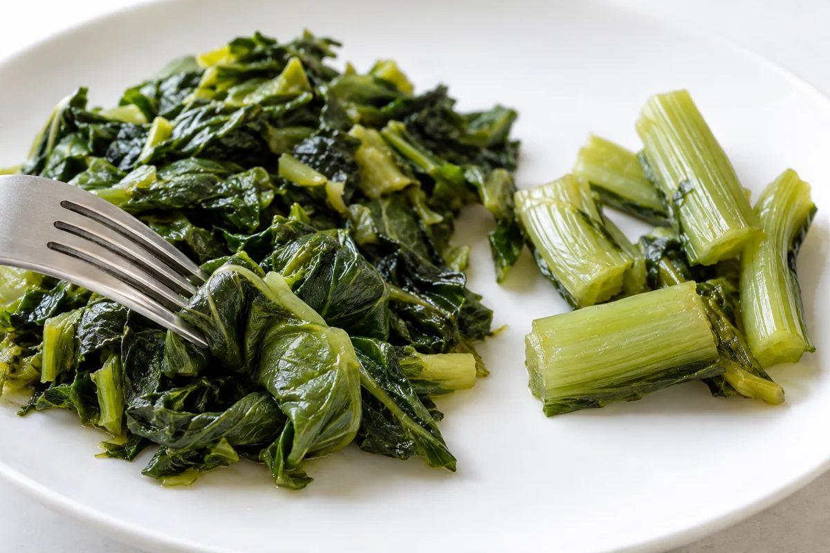 Cooked leaf and stem texture Cooked mustard leaf pieces and separate petiole pieces