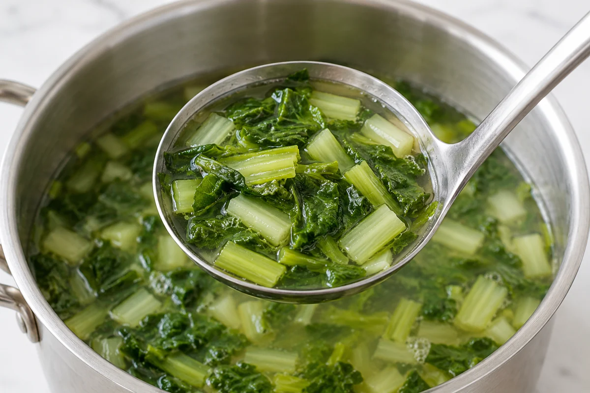 Cooked mustard leaf and petiole pieces in a soup ladle
