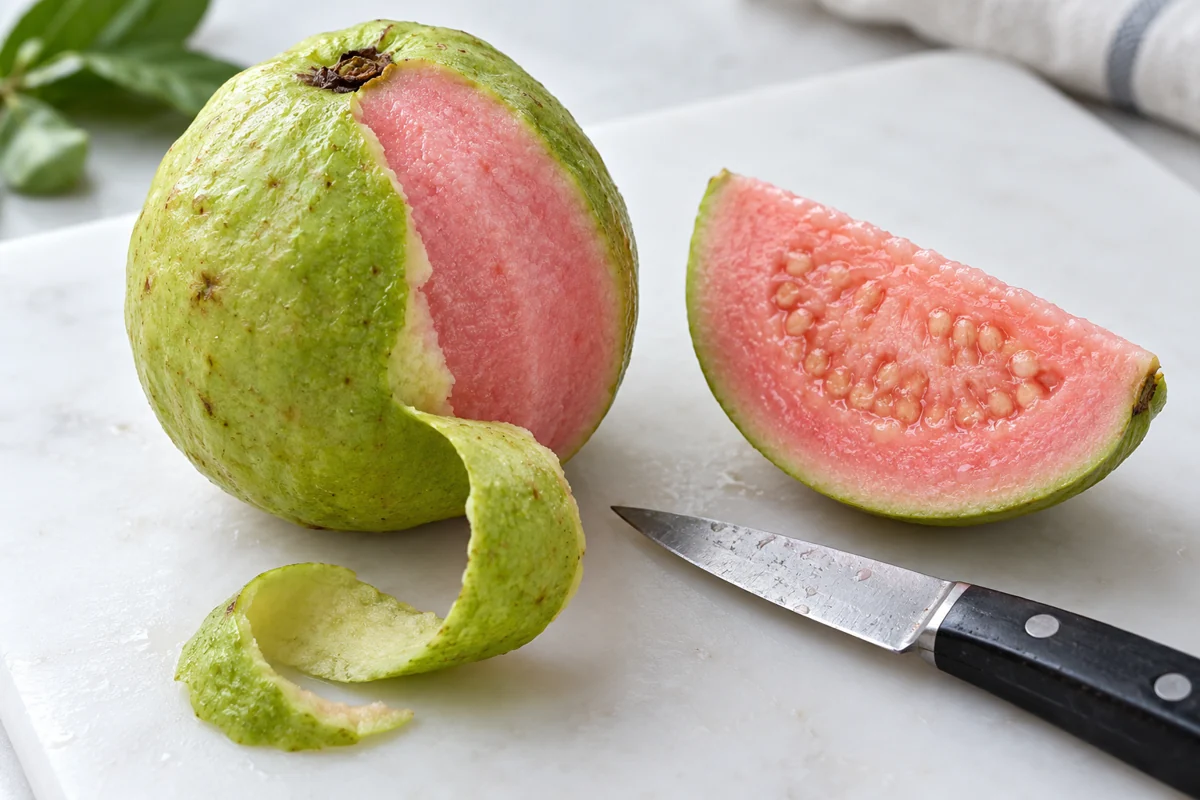 Thin green peel removed from a pink guava Thin green peel removed from a pink guava