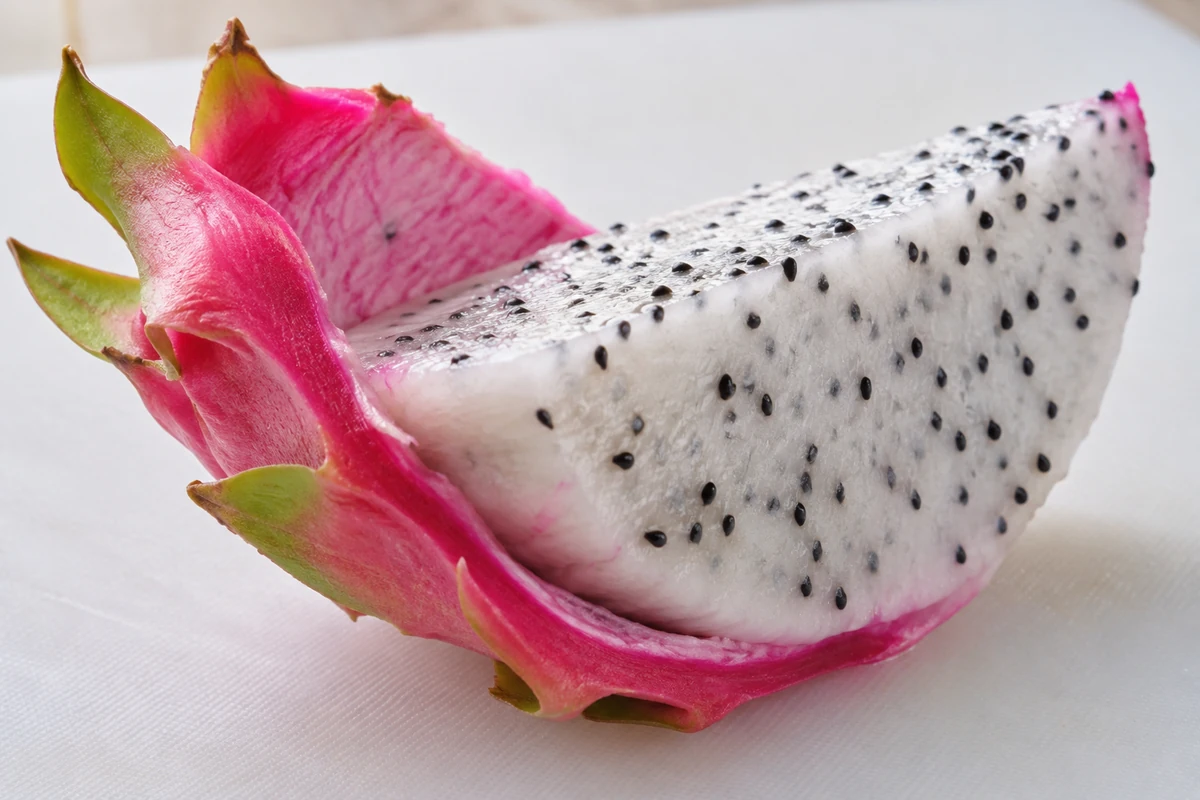 White dragon fruit flesh separating from its pink peel White dragon fruit flesh separating from its pink peel