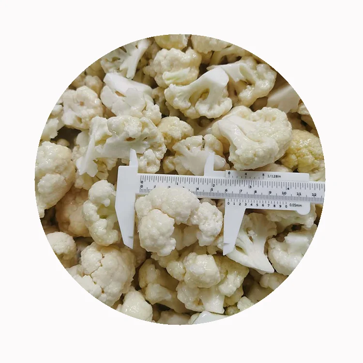 Genuine GreenLand cauliflower floret photograph Compact pale cauliflower florets beside a caliper