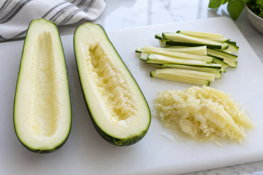 Halved zucchini with firm outer flesh and a soft seed core