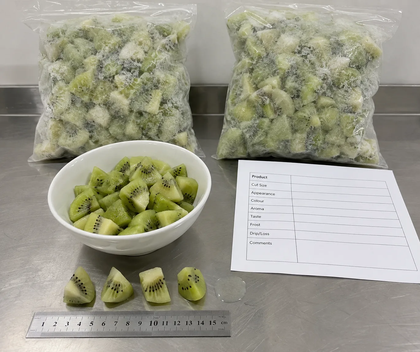 Illustrative sample check for frozen kiwi cut, frost and thaw drip; bags are not GreenLand packaging.