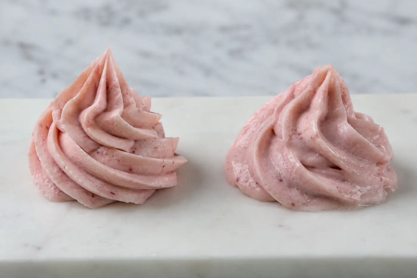 Defined and slumped strawberry frosting swirls in a piping trial
