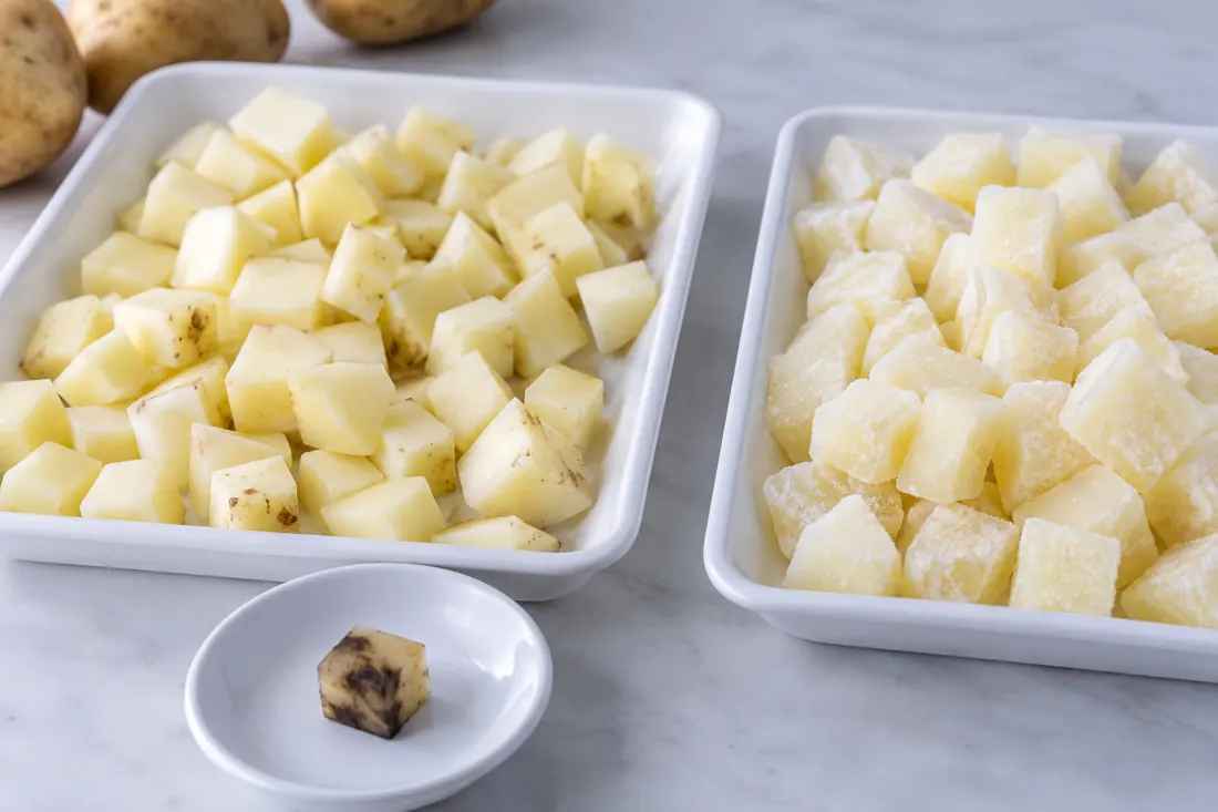 Raw and frozen potato cubes with a separated dark piece