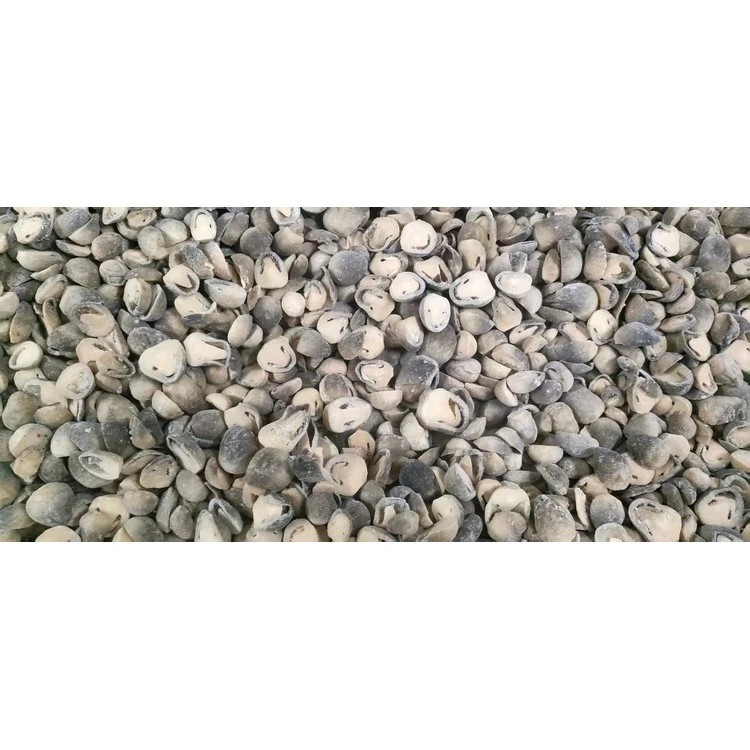 Cut straw mushroom pieces with visible cut faces in a bulk source lot